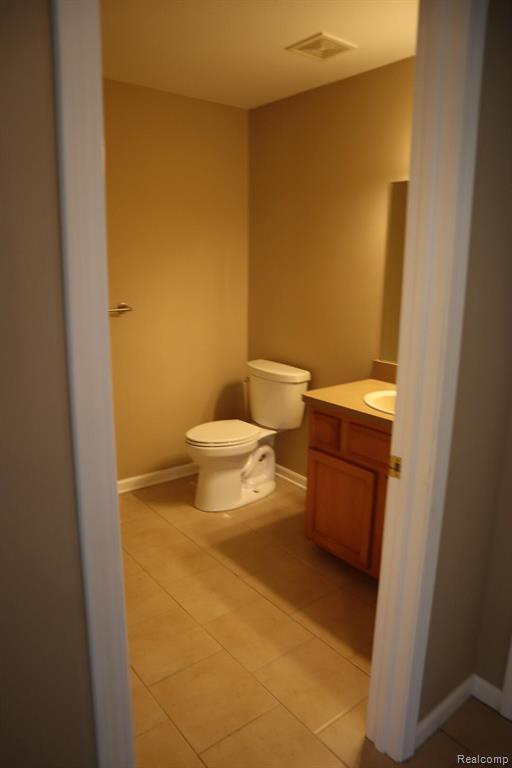 Bathroom featuring vanity and dark tile patterned flooring