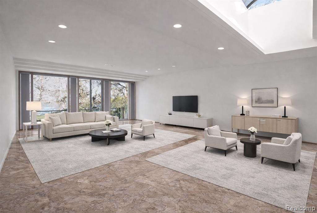 Living room with recessed lighting and stone finish floors