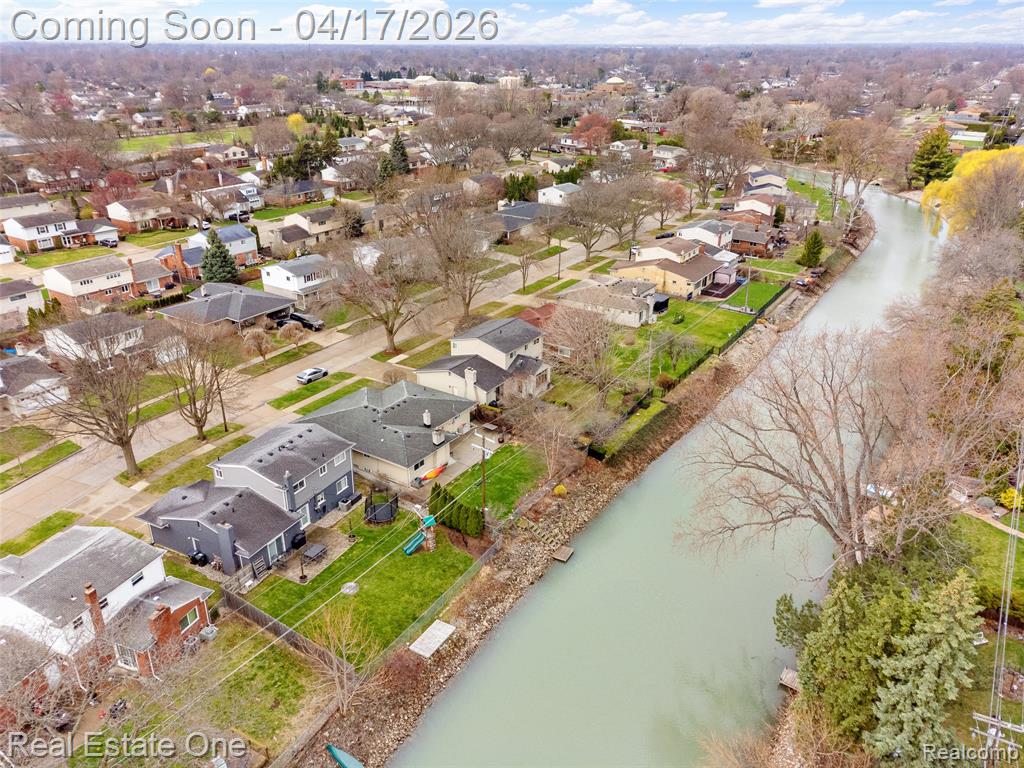 Aerial perspective of suburban area featuring a large body of water