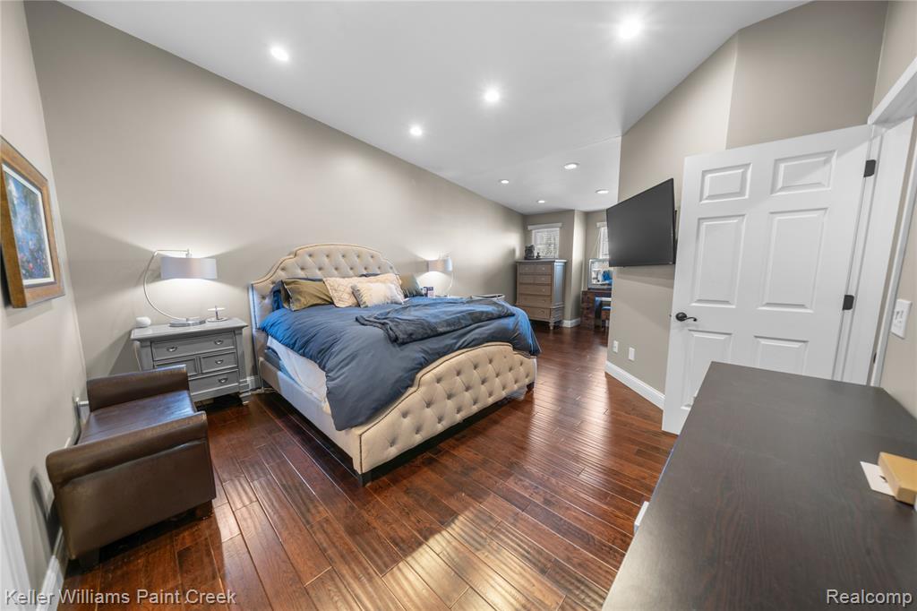 Bedroom with dark wood-style flooring and recessed lighting
