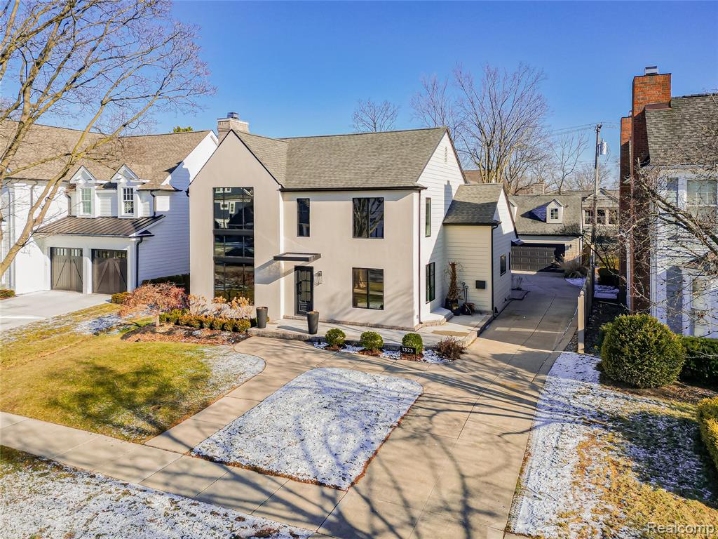 Snow covered rear of property featuring a chimney