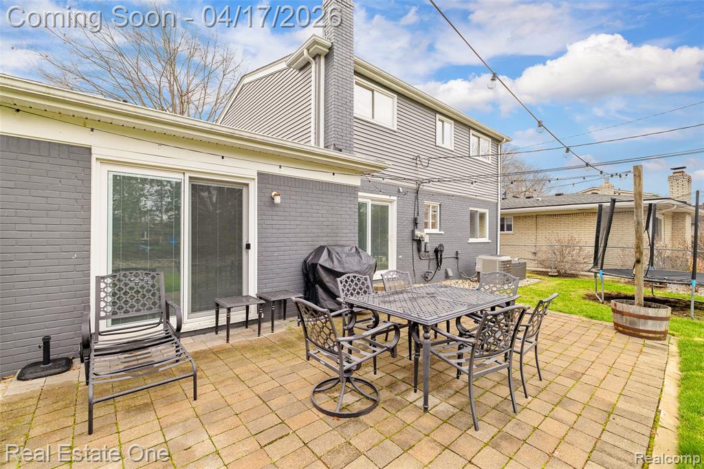 View of patio / terrace featuring a trampoline, a grill, and outdoor dining space