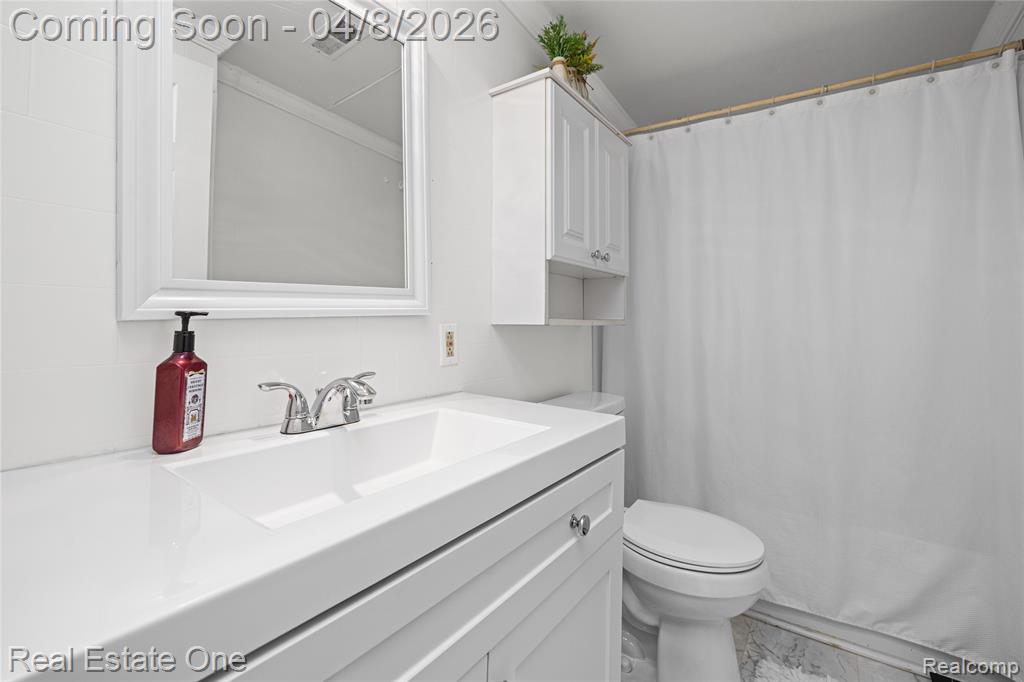 Full bathroom with vanity and a shower with curtain