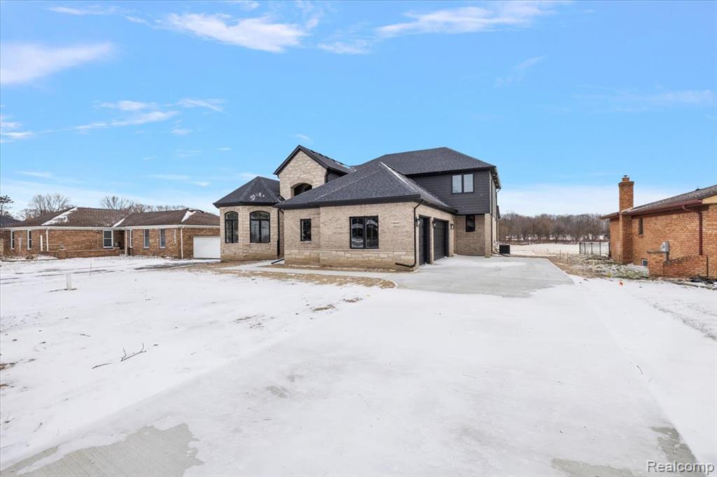 French provincial home featuring stone siding