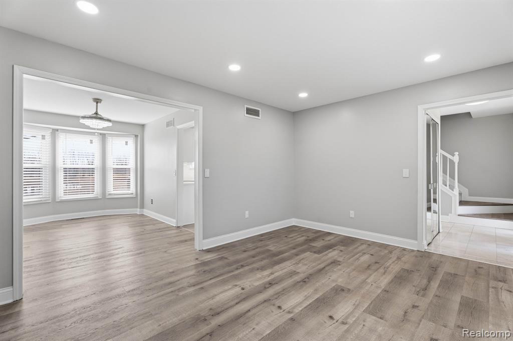 Unfurnished room with light wood finished floors and recessed lighting