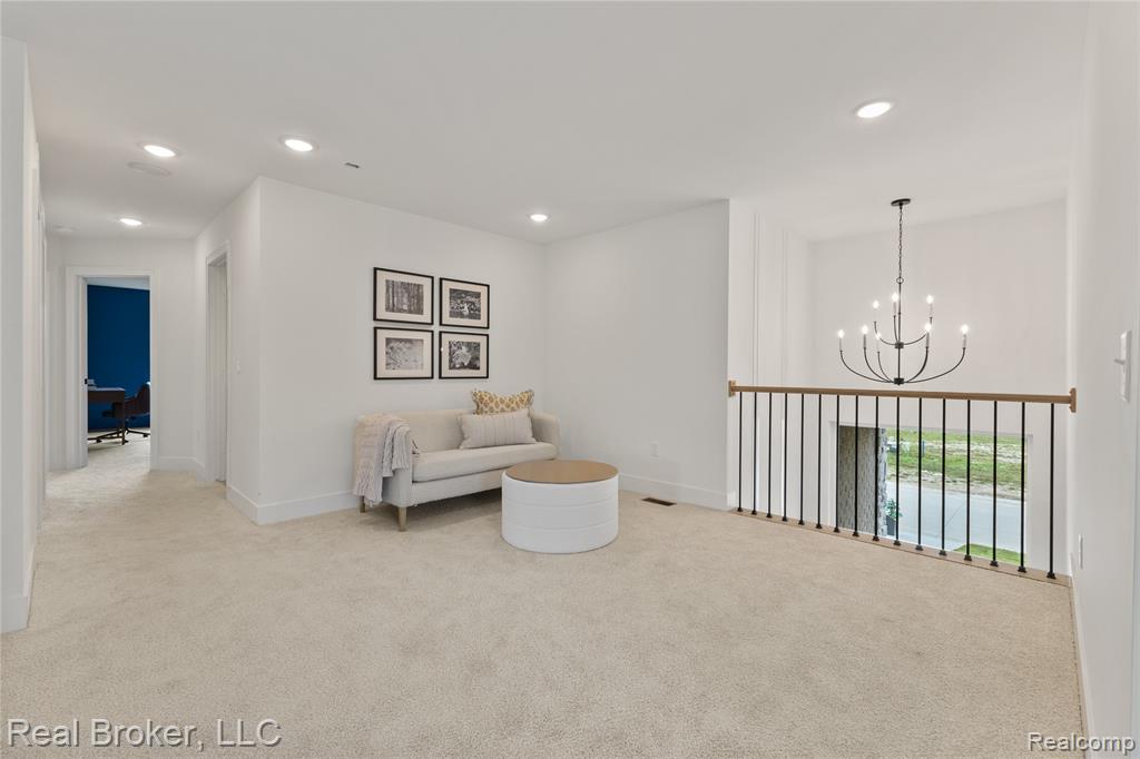 Sitting room featuring a chandelier, light colored carpet, and recessed lighting