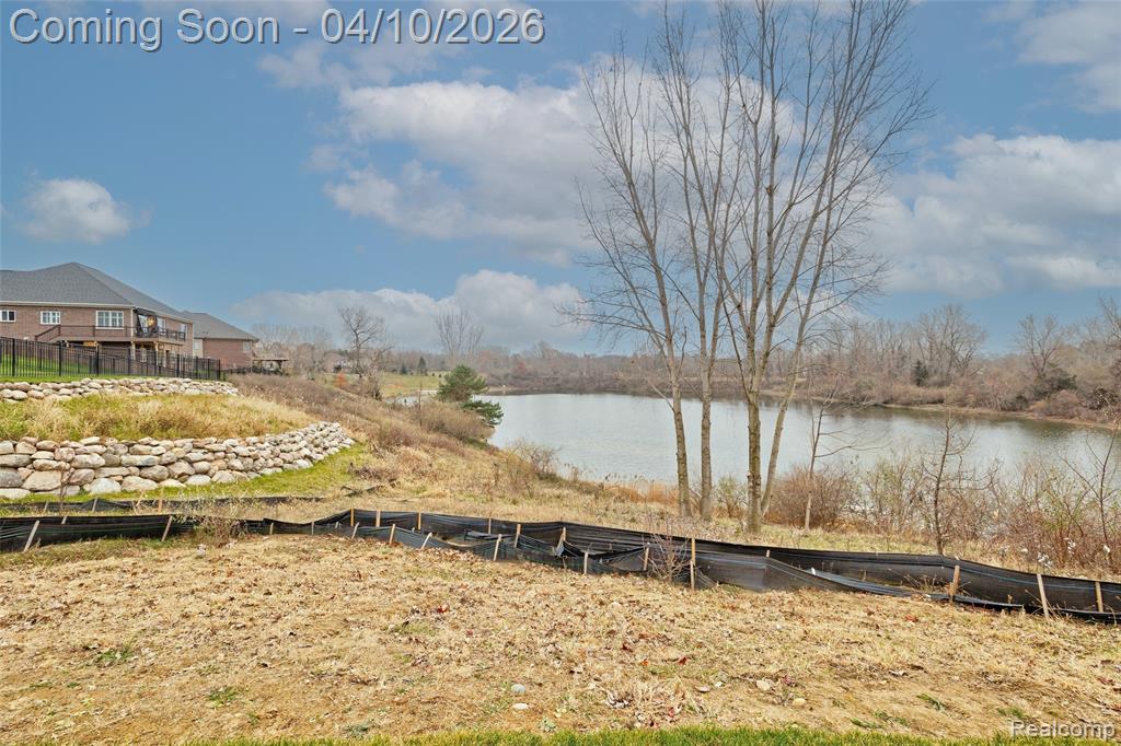 View of yard with a water view