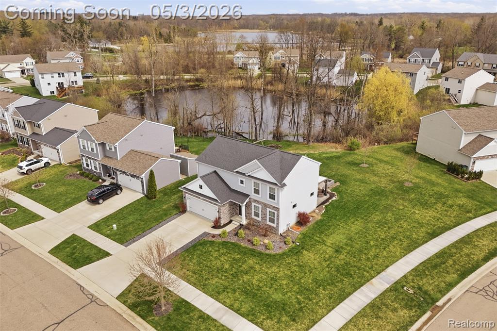 Aerial perspective of suburban area with a large body of water