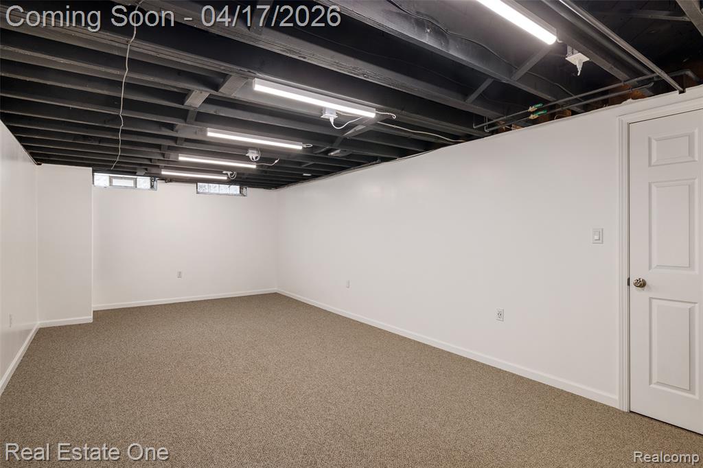 Basement with carpet floors and baseboards