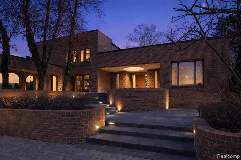 View of front facade with brick siding and a patio area