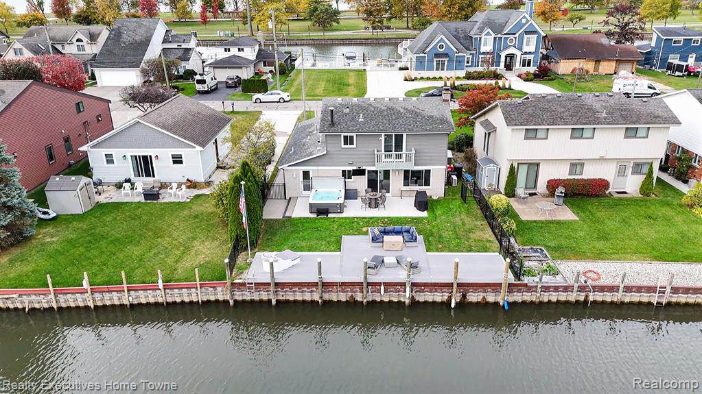 Aerial perspective of suburban area with a nearby body of water