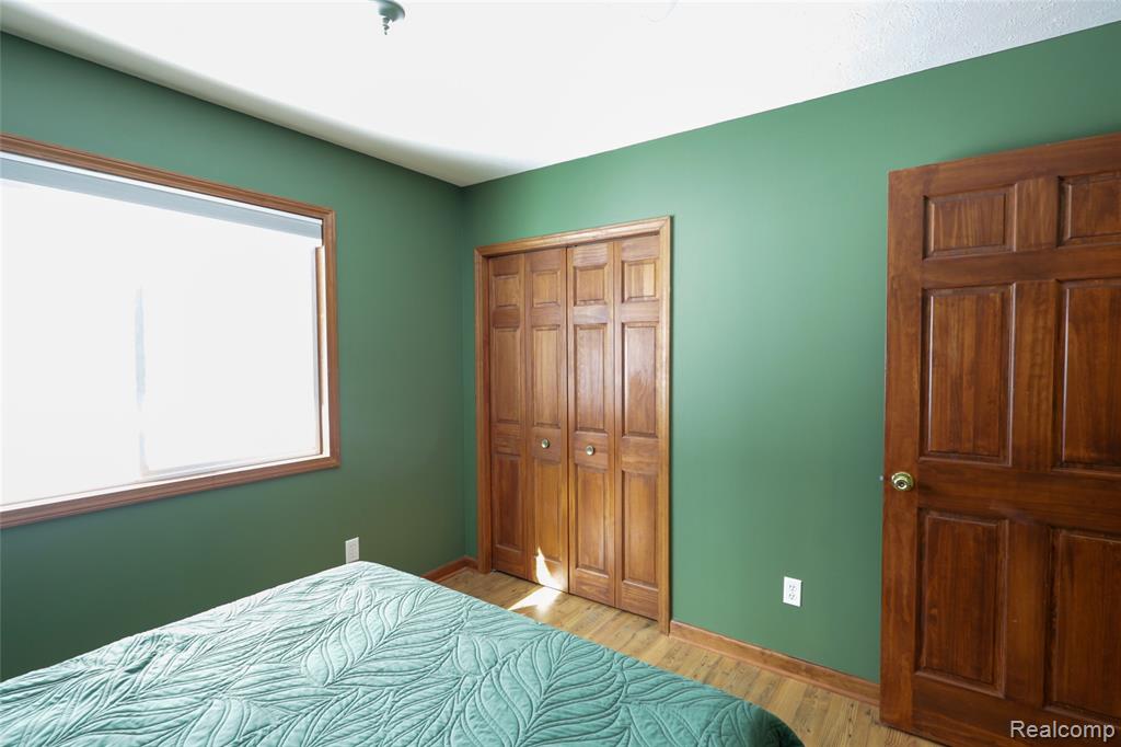 Bedroom featuring light wood finished floors and a closet