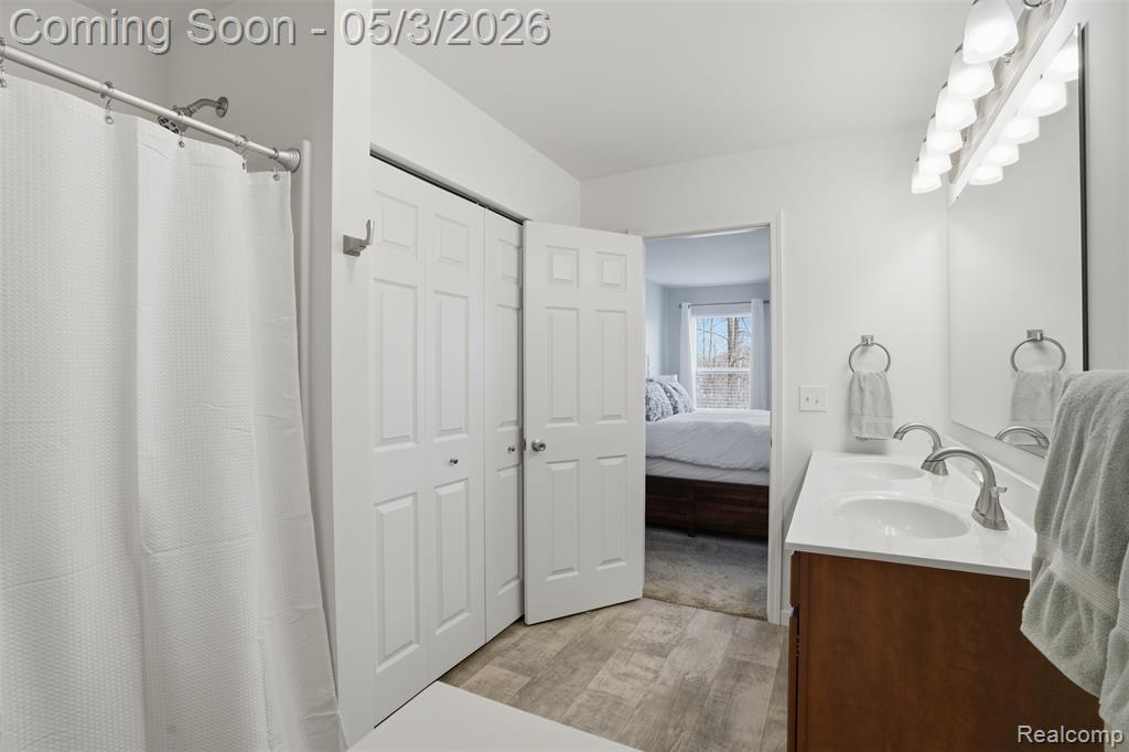 Primary Bathroom featuring a double vanity and shower