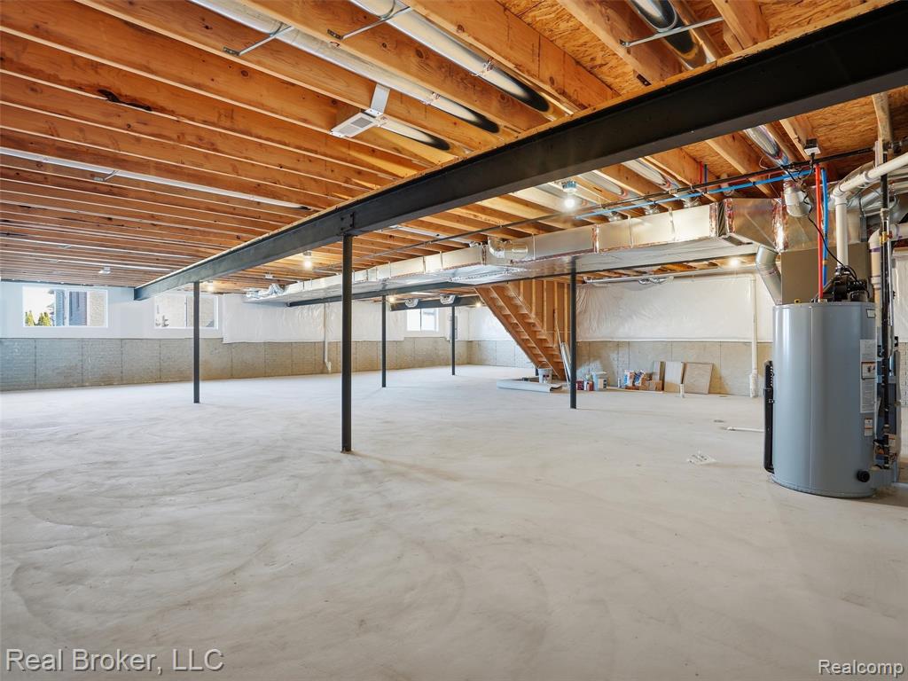 Below grade area featuring stairs and gas water heater