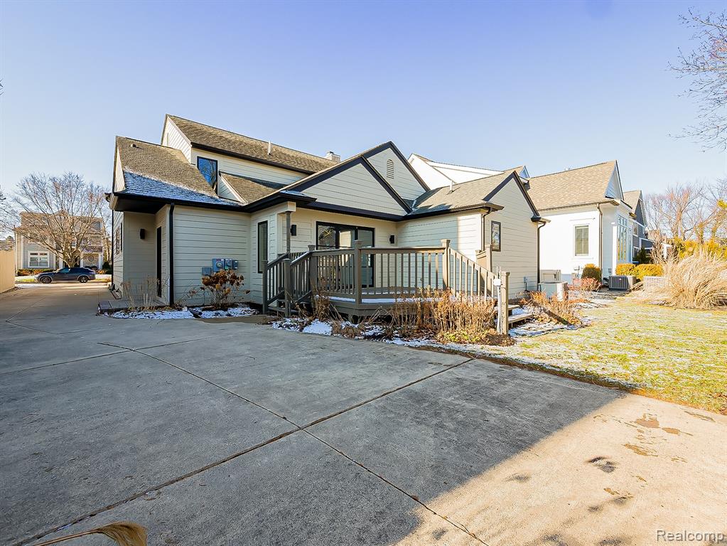 View of front of house with a deck and a front yard