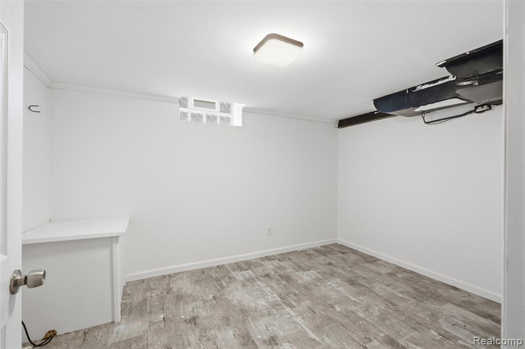 Finished below grade area with light wood-type flooring