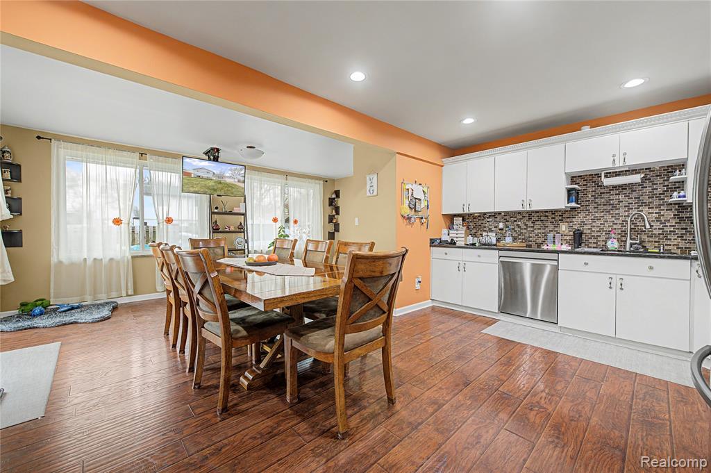 Dining area featuring dark wood finished floors and recessed lighting