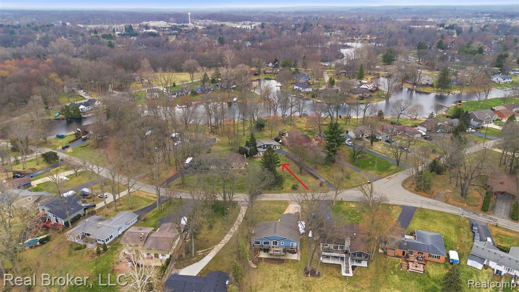 Aerial overview of property's location featuring nearby suburban area