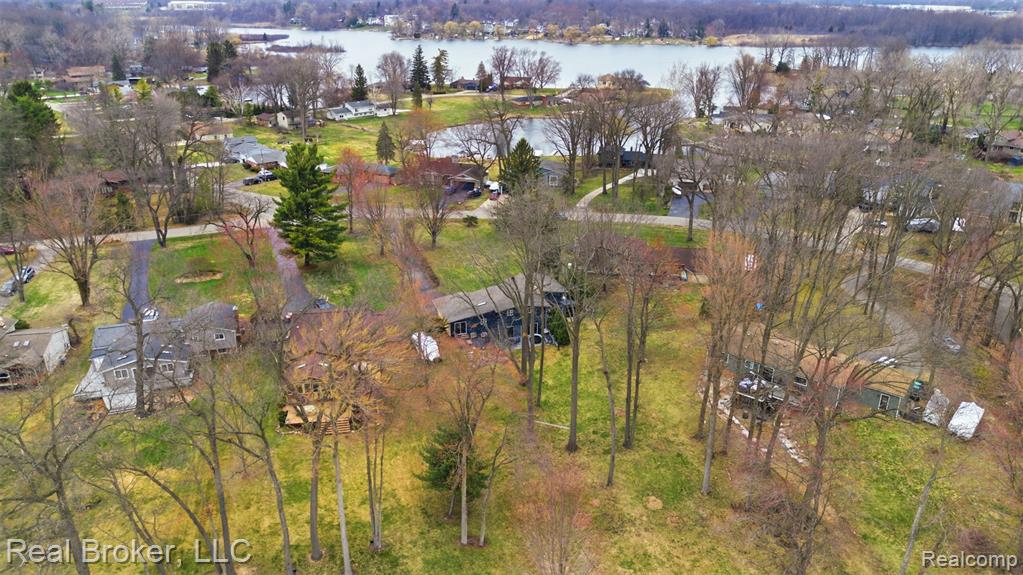 Aerial perspective of suburban area featuring a nearby body of water