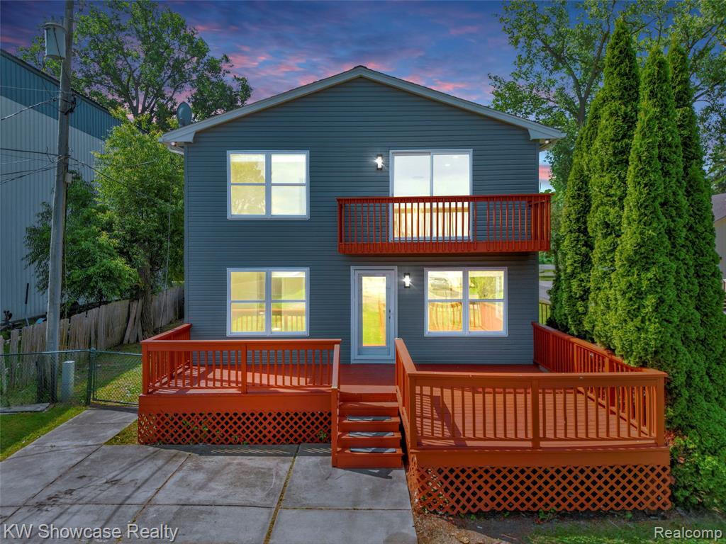 Two-story residence featuring a gray exterior with white trim windows