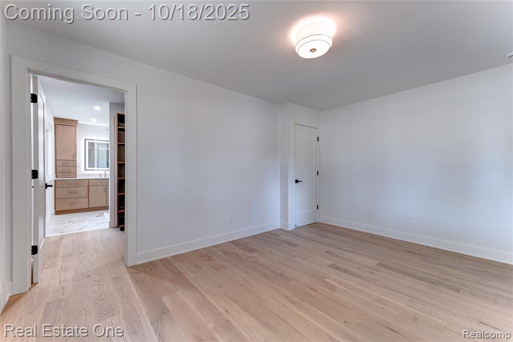 Spare room featuring light wood finished floors and baseboards