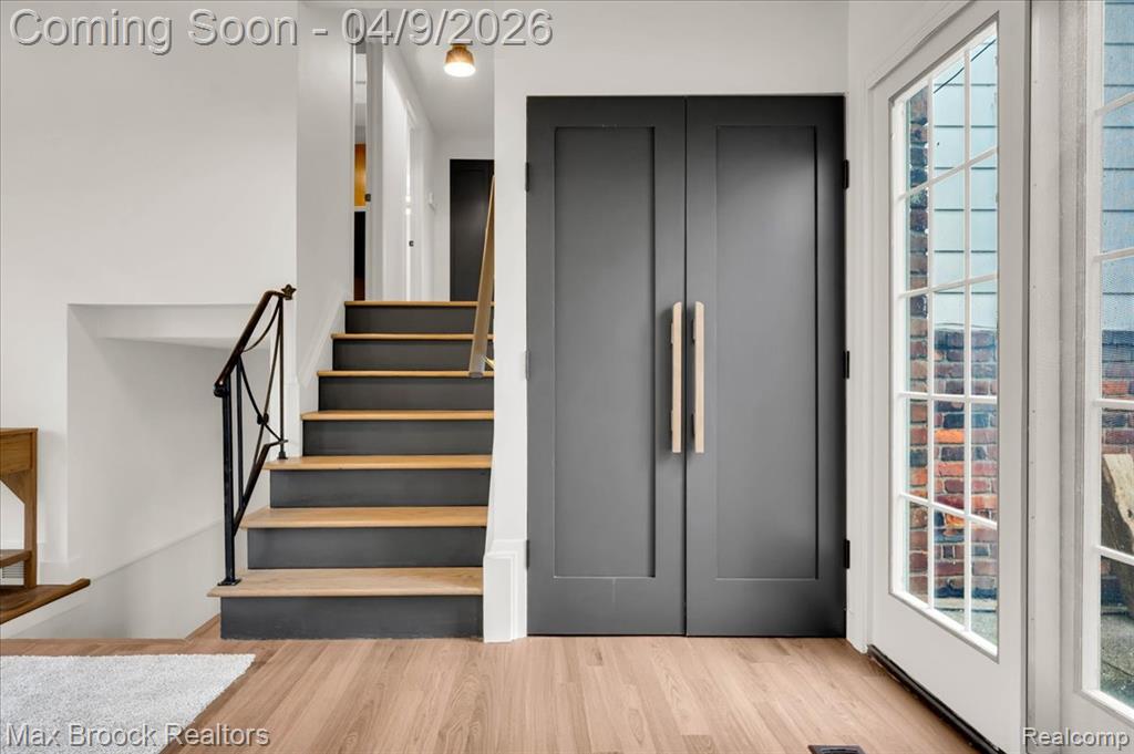 Stairway featuring wood finished floors