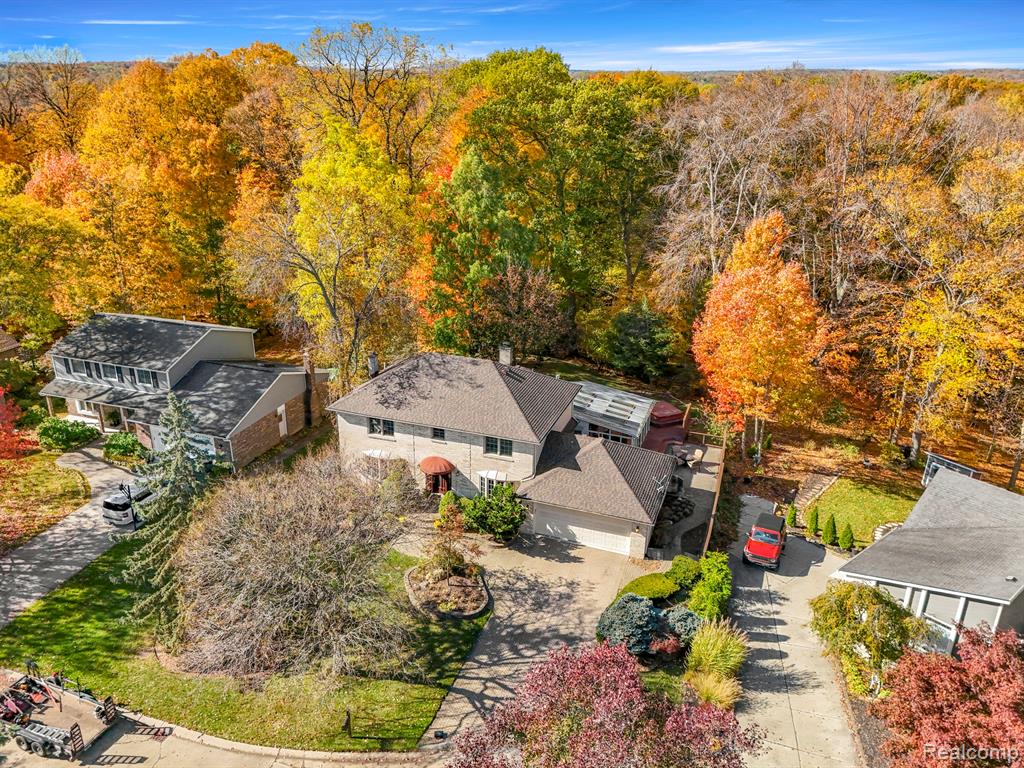Photo for 41804 Waterfall Road, Northville, MI 48168 - listing #20251054010 View from above of property with a forest