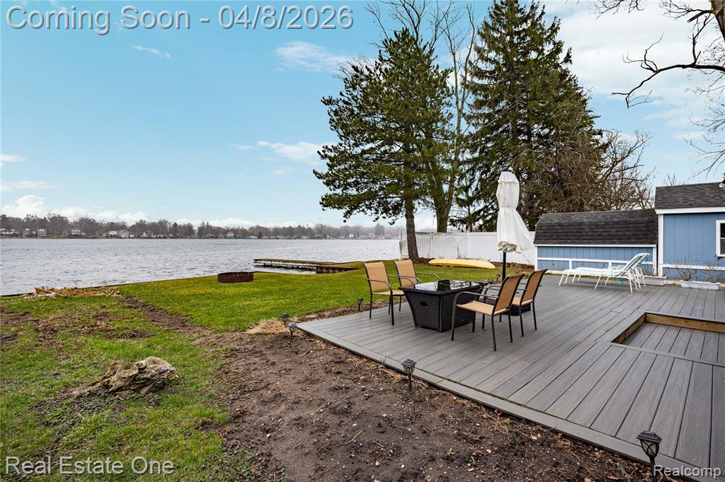 Deck featuring a water view and a lawn