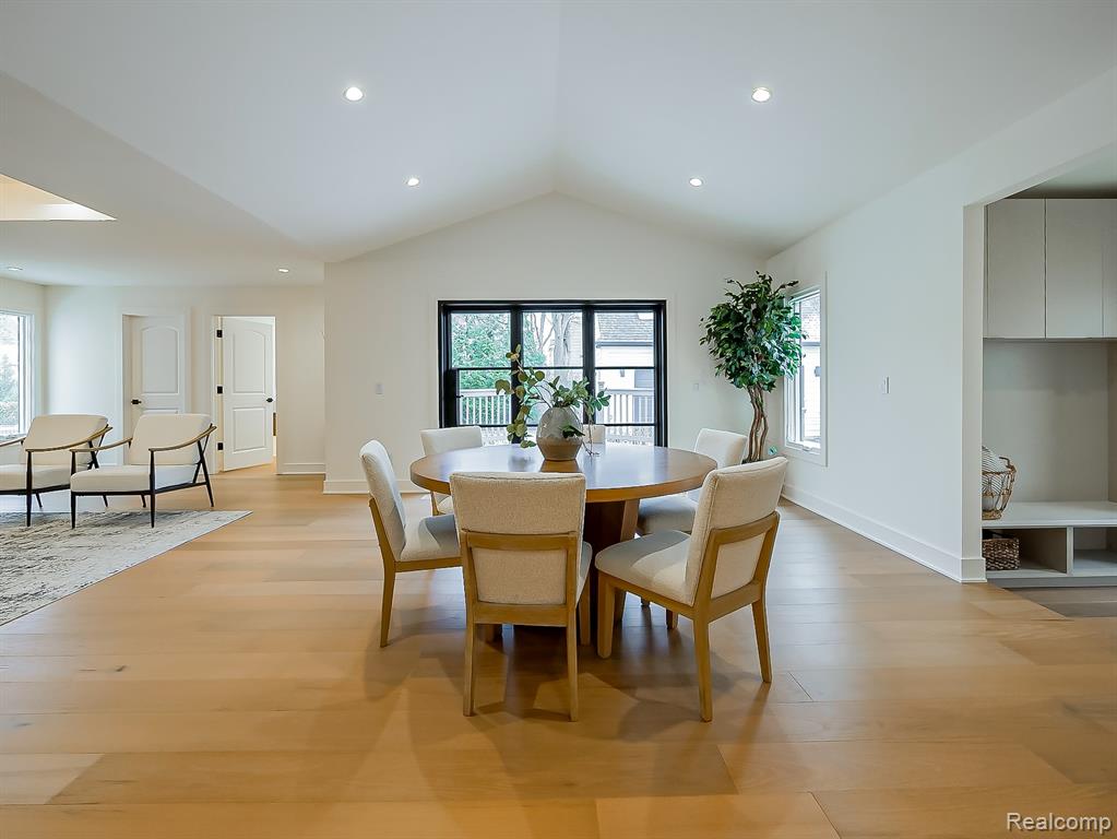 Dining area featuring lofted ceiling, light wood-type flooring, healthy amount of natural light, and recessed lighting