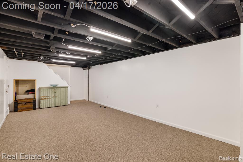 Finished basement featuring carpet flooring and baseboards