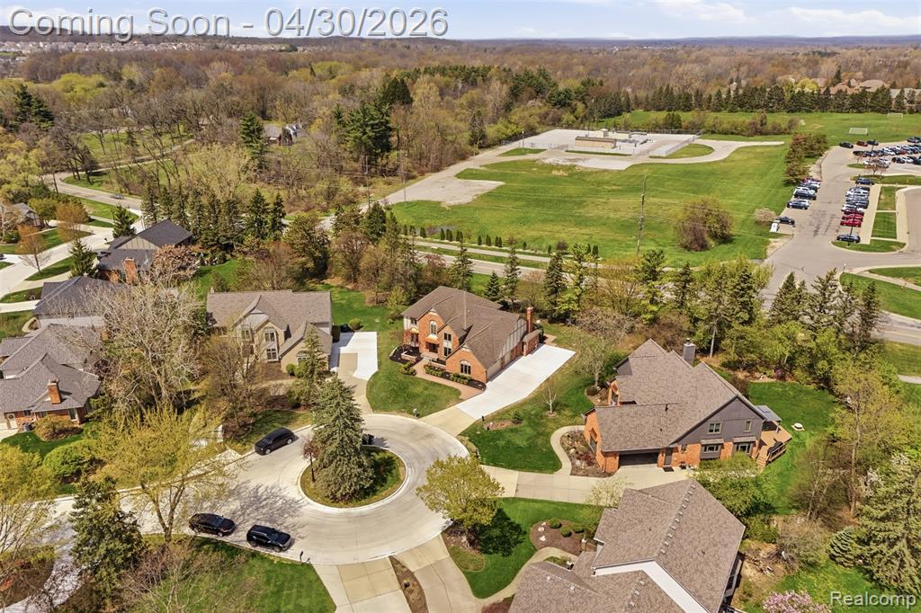 Aerial perspective of suburban area featuring a heavily wooded area