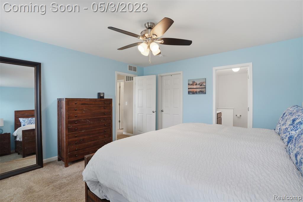 Bedroom with light carpet and ceiling fan