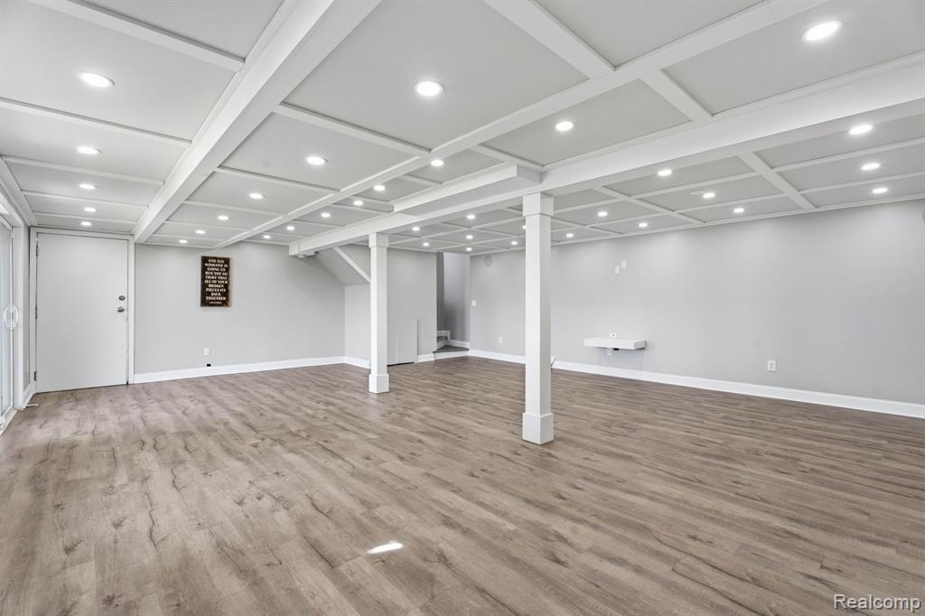 Finished below grade area with recessed lighting and light wood-type flooring