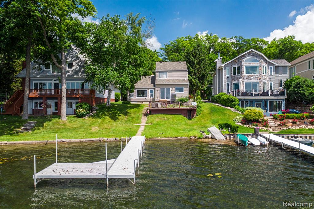 Dock area featuring a lawn and a deck with water view
