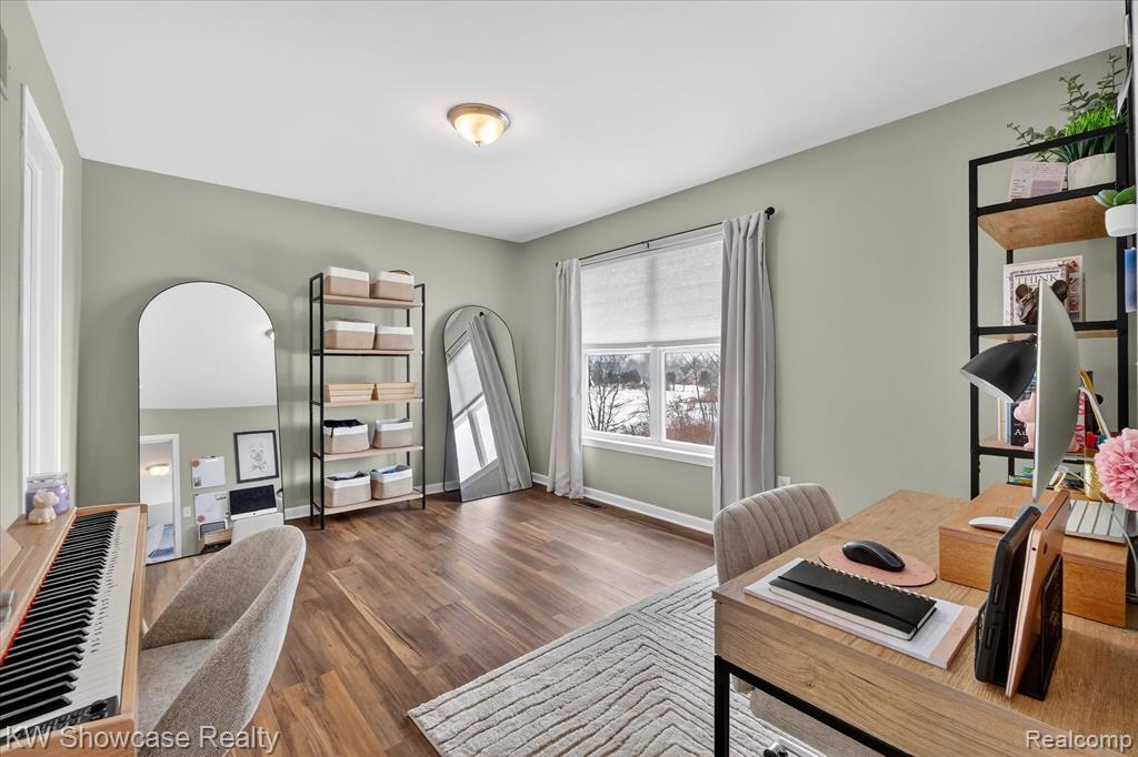 Office area featuring dark wood-type flooring and baseboards