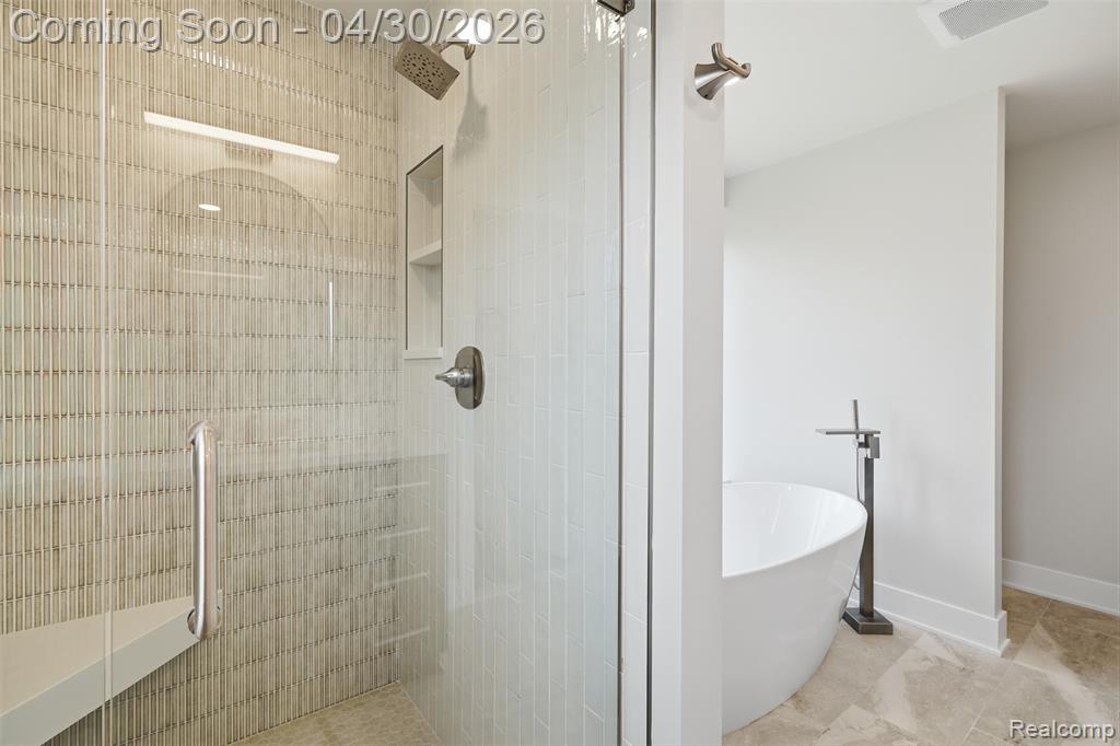Primary Bathroom with a shower w/ euro glass door and a freestanding bath
