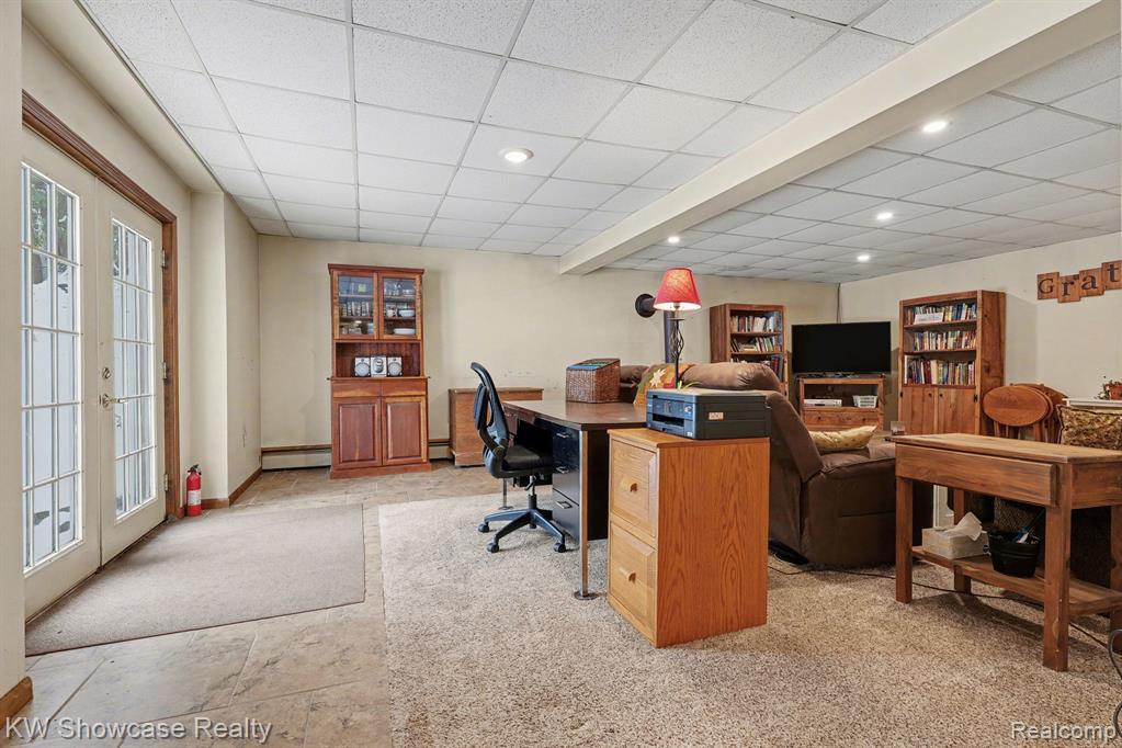 Home office with a paneled ceiling, french doors, and recessed lighting