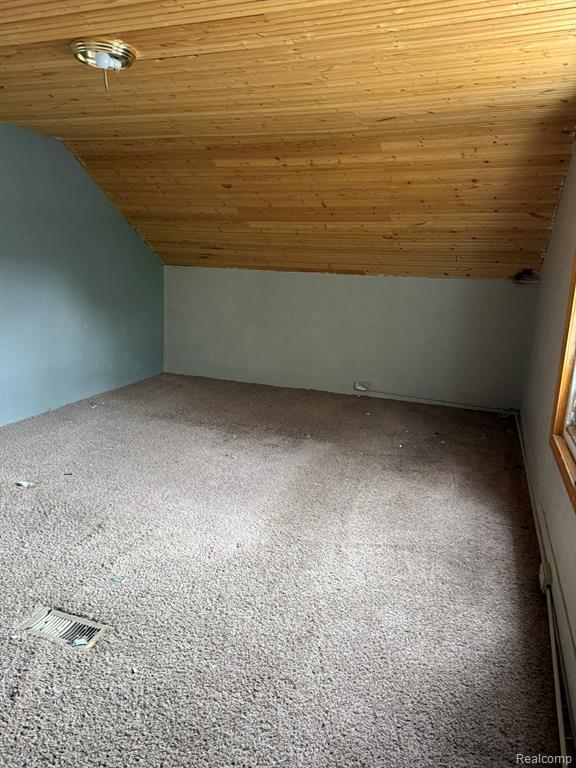 Bonus room featuring carpet and a vaulted wood ceiling