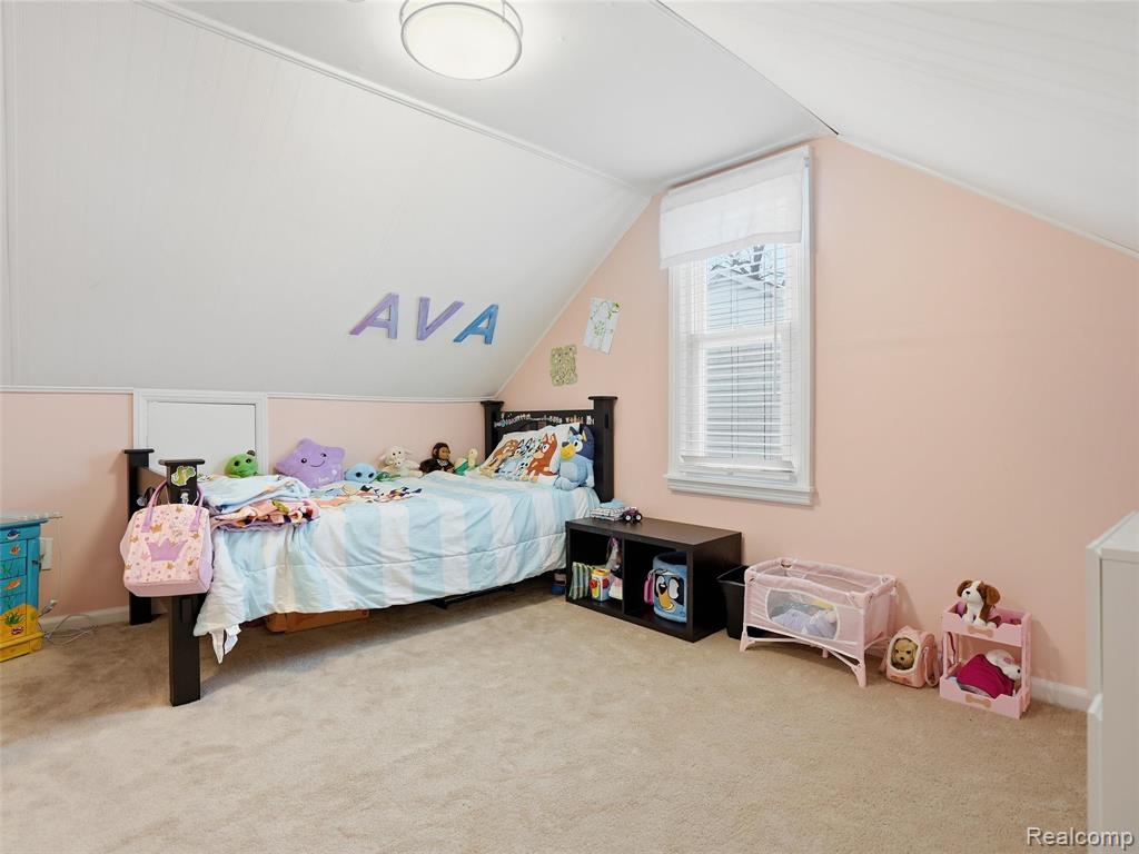 Carpeted bedroom with vaulted ceiling