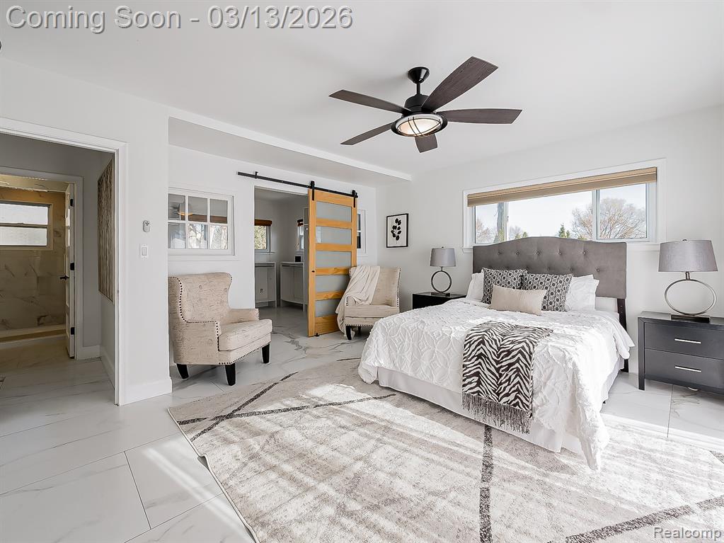 Bedroom with light marble finish flooring and a ceiling fan