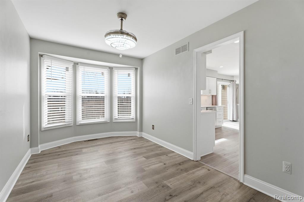 Spare room with light wood-style floors and baseboards