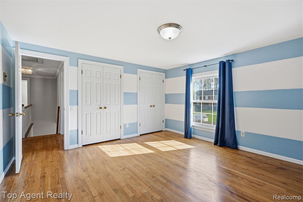 Below grade area featuring a paneled ceiling, carpet, and freestanding refrigerator