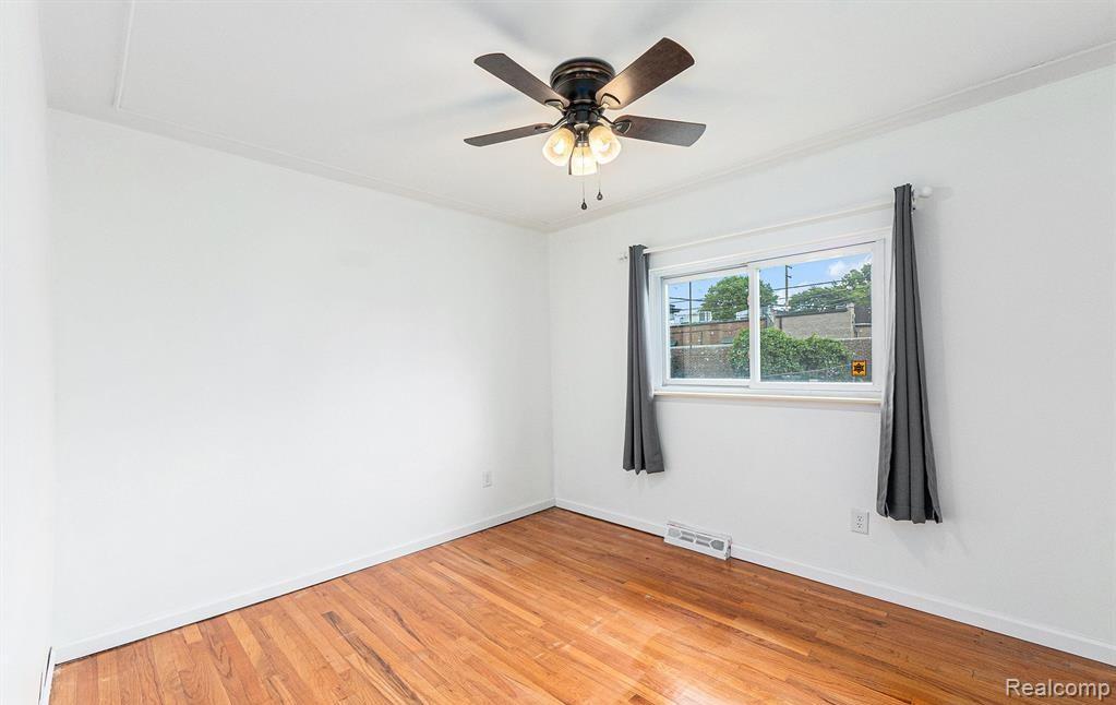 Unfurnished room with light wood-style flooring and ceiling fan
