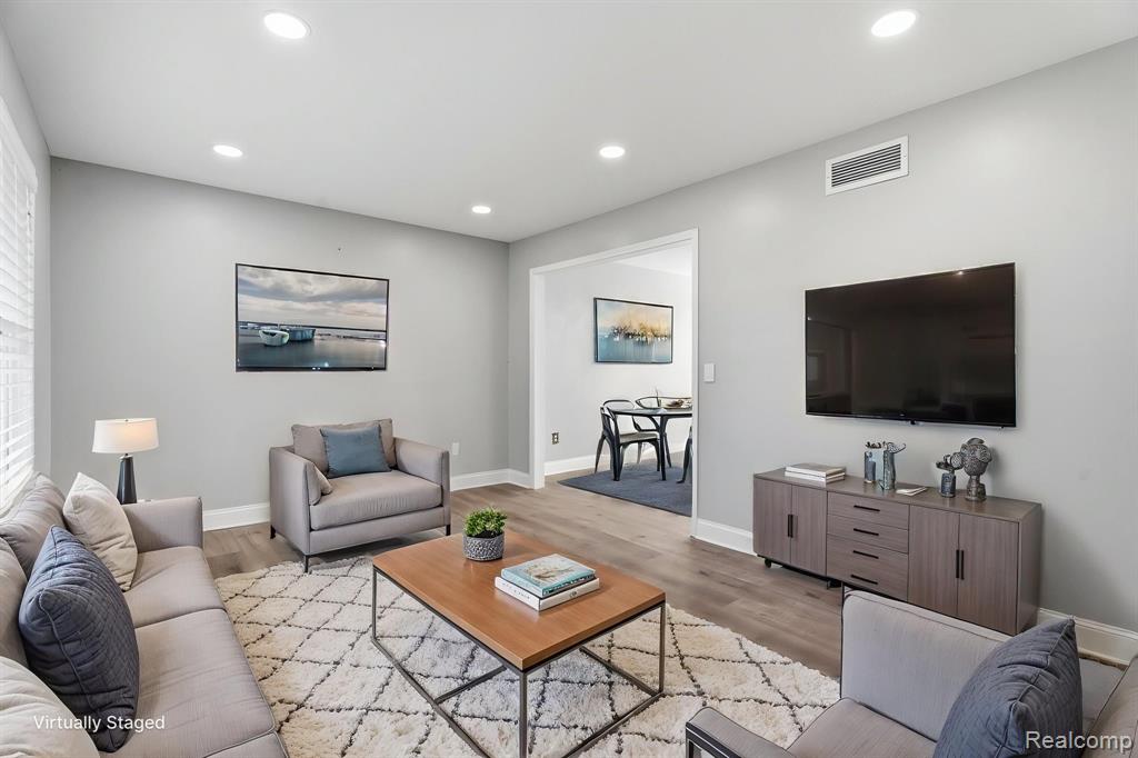 Living room featuring wood finished floors and recessed lighting
