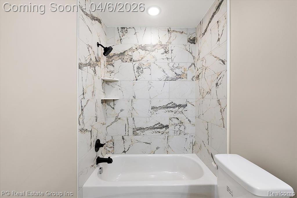 Bathroom with toilet and shower / bath combination