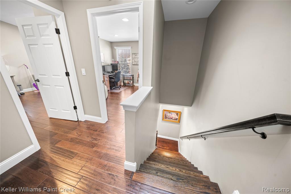 Stairway featuring hardwood / wood-style flooring and recessed lighting