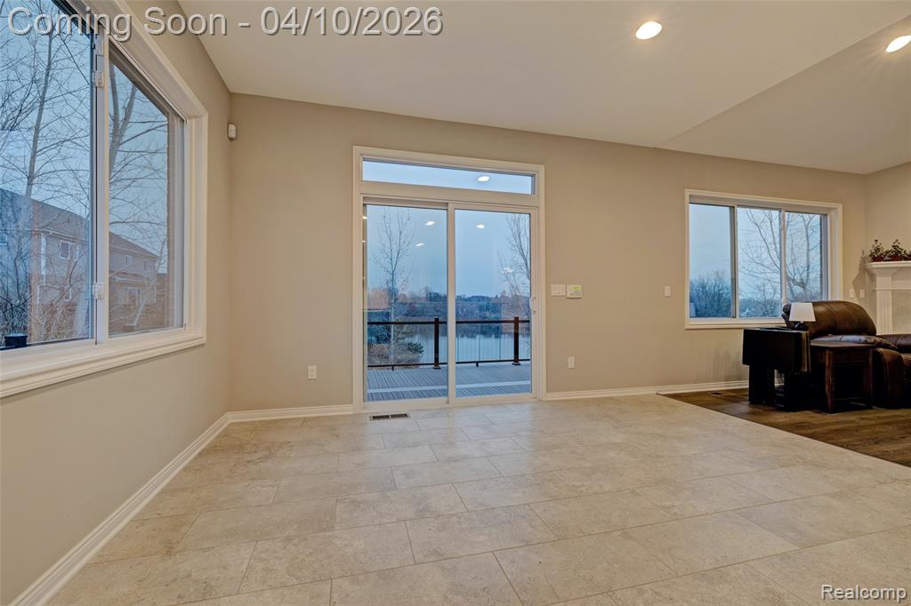 Unfurnished living room with a water view and recessed lighting