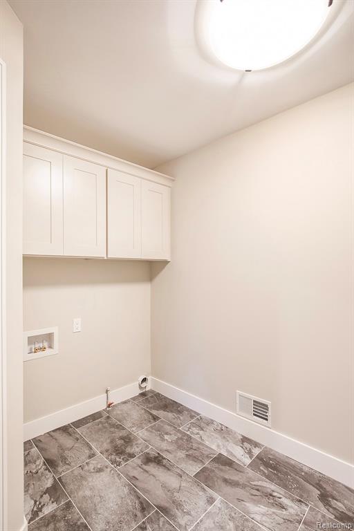 Laundry area featuring hookup for a washing machine, gas dryer hookup, and cabinet space