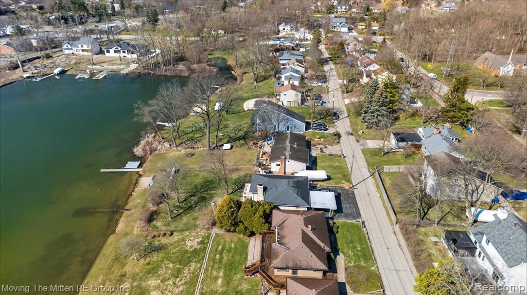 Aerial view of property's location with a large body of water and nearby suburban area