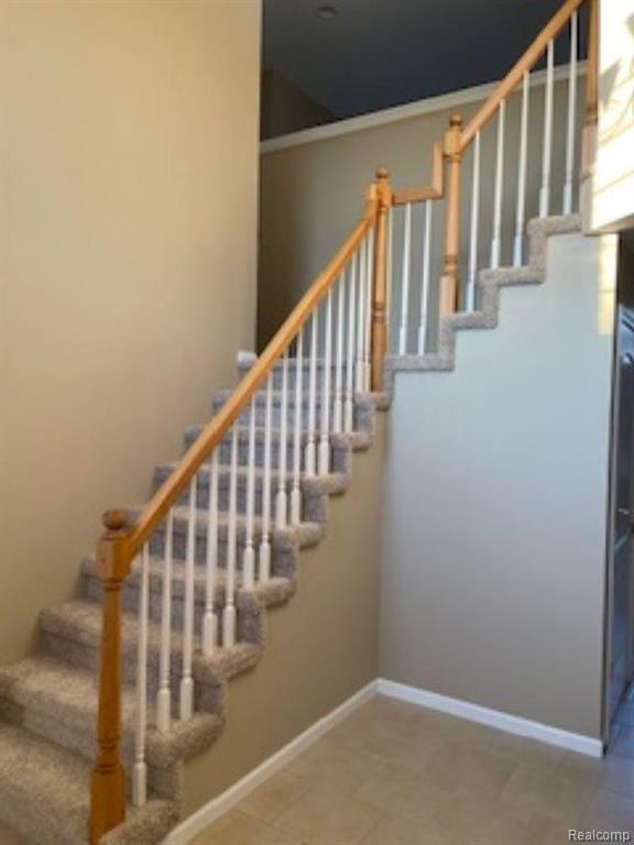 Entryway featuring a towering ceiling, healthy amount of natural light, and a chandelier